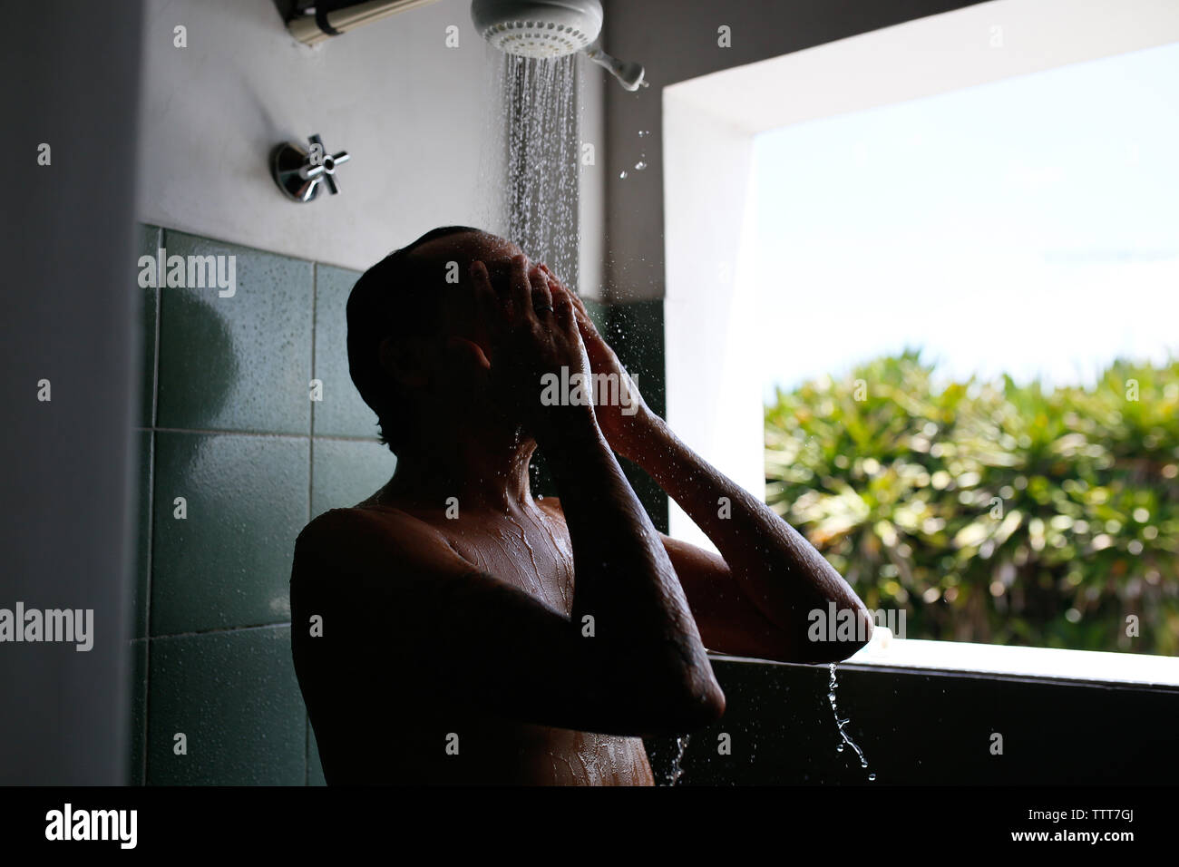 Man In Shower High Resolution Stock