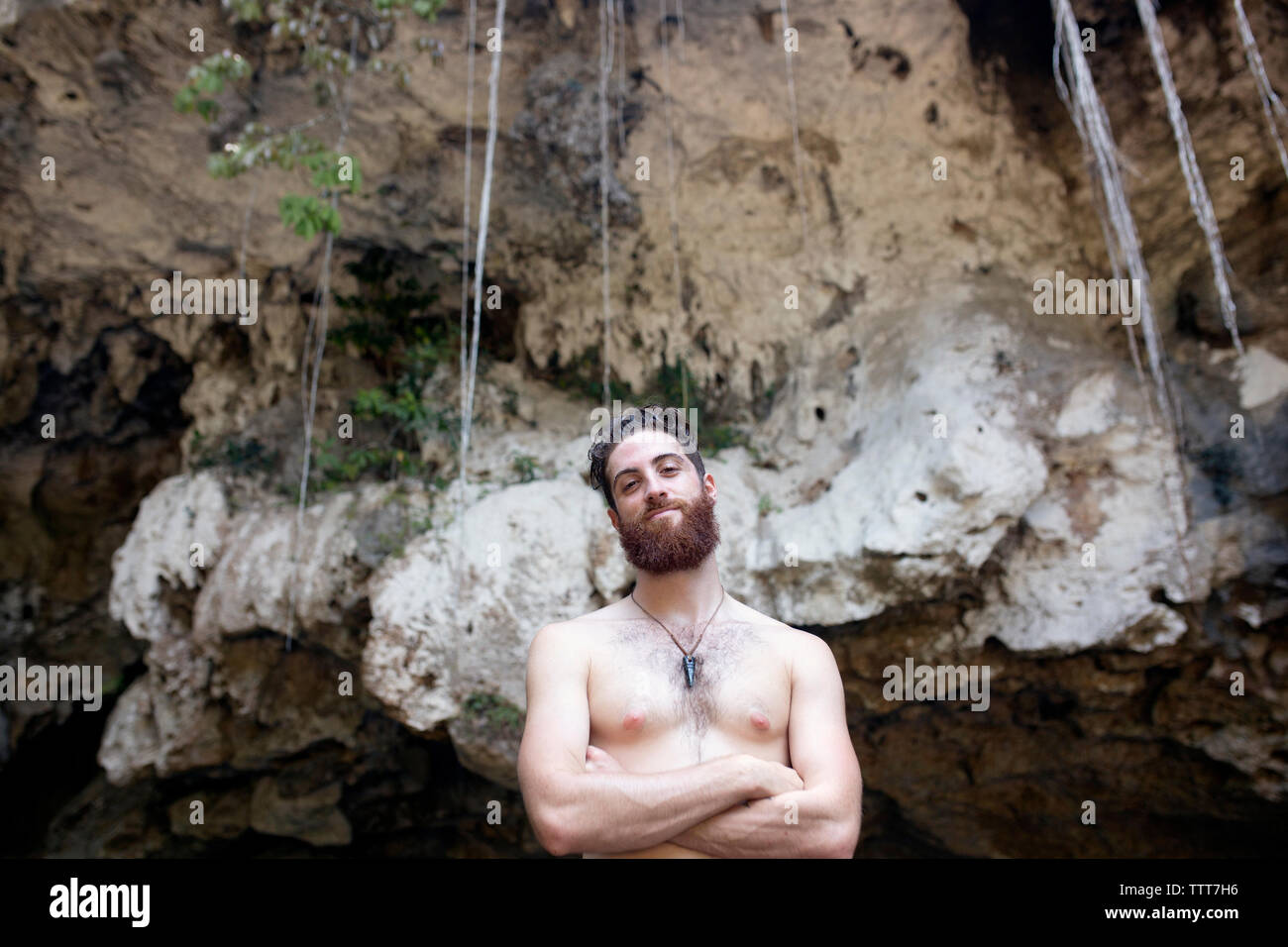 Man outside a cave with arms crossed Stock Photo - Alamy