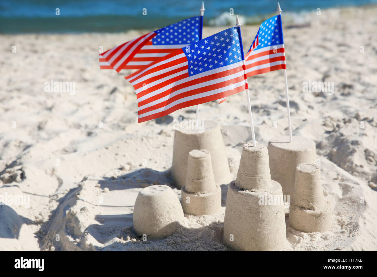 Sand castle with American flags on beach Stock Photo Alamy