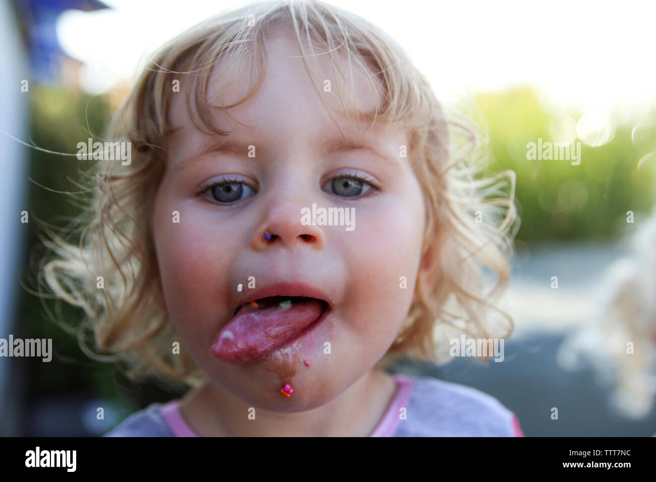Close-up portrait of girl sticking out tongue Stock Photo