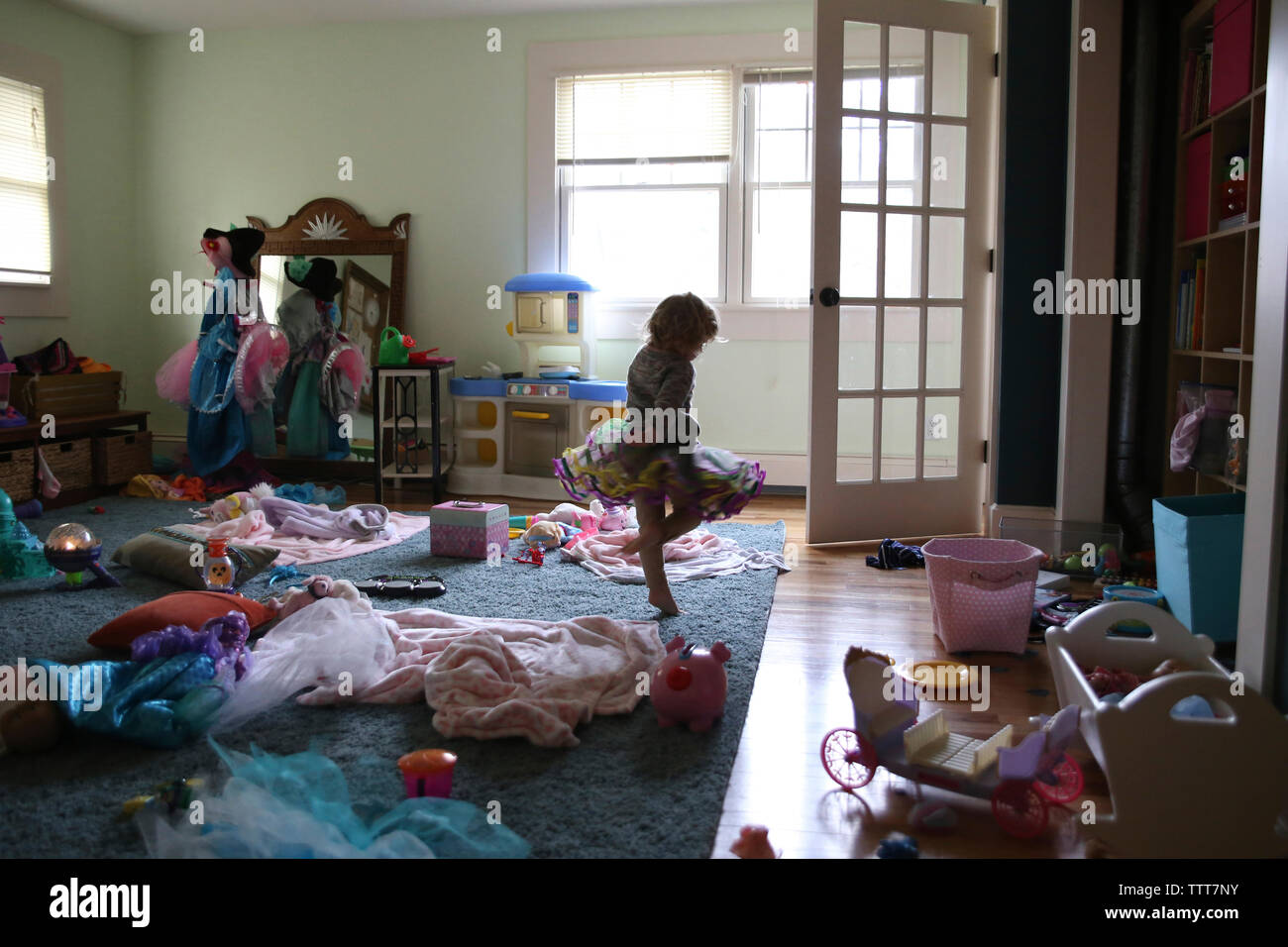 Girl dancing in messy room at home Stock Photo