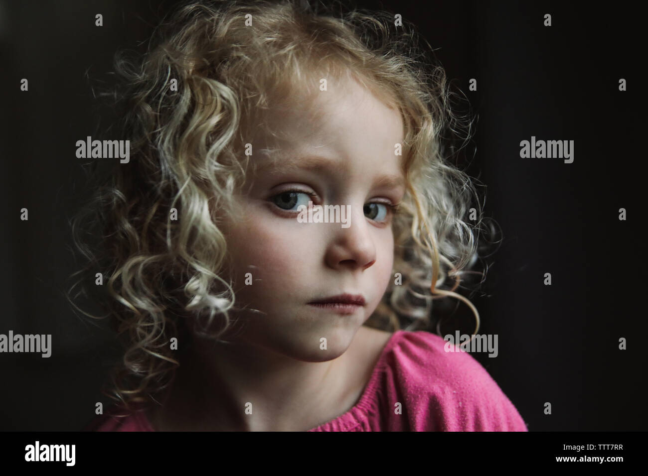 Close-up portrait of girl against black background Stock Photo