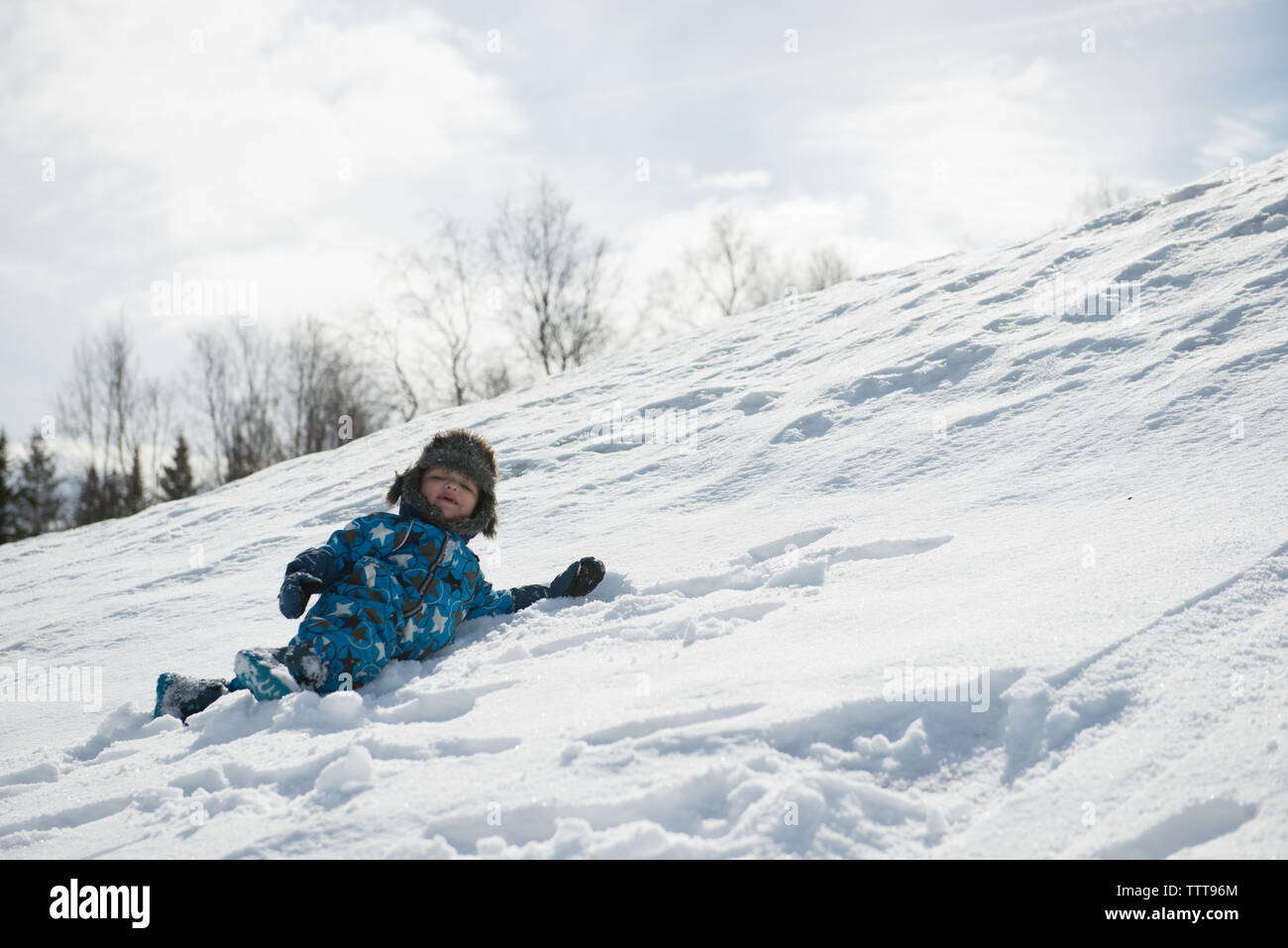 Boy kid child playing in snow Stock Photo