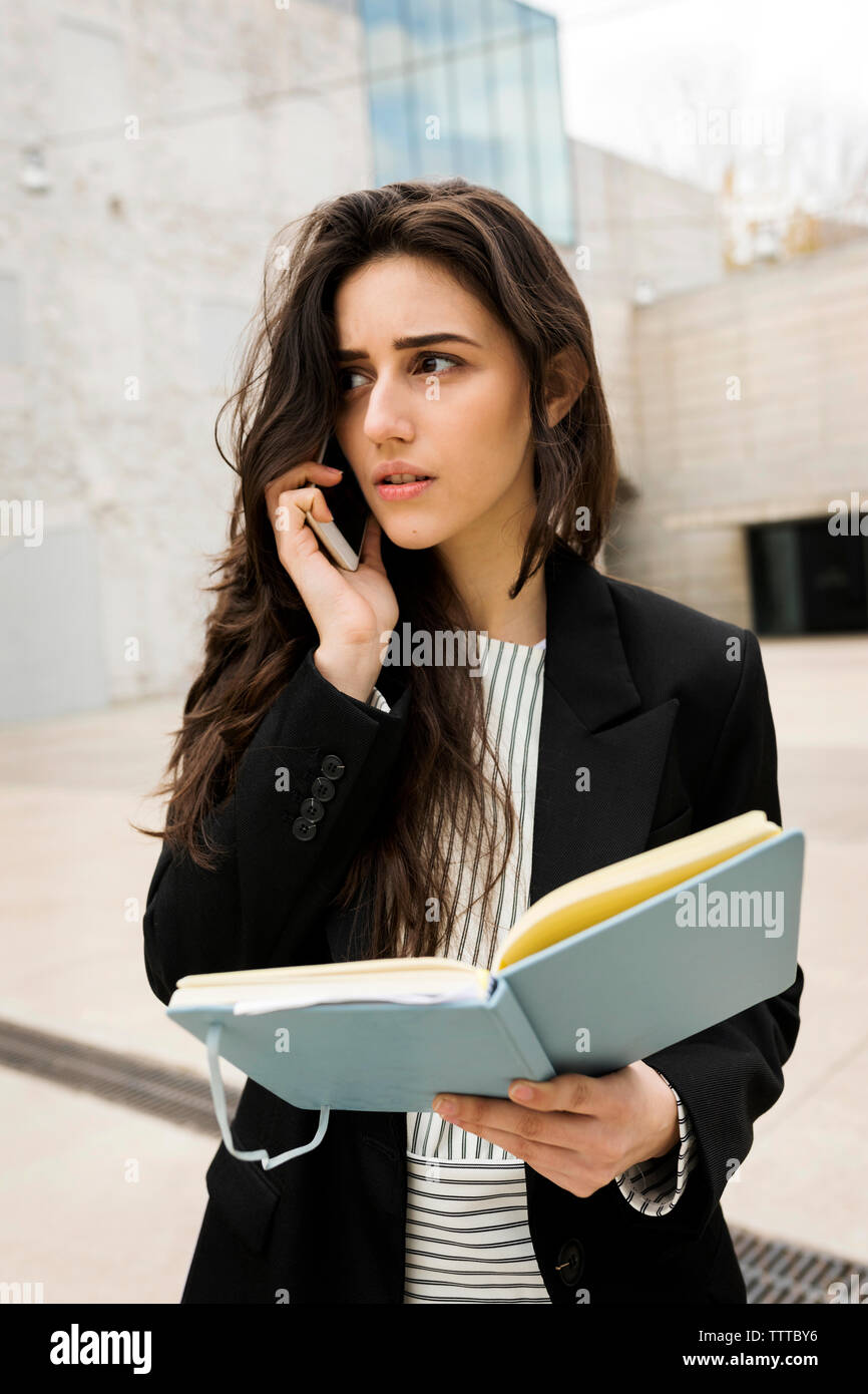 Concern young attractive woman talking by the phone Stock Photo