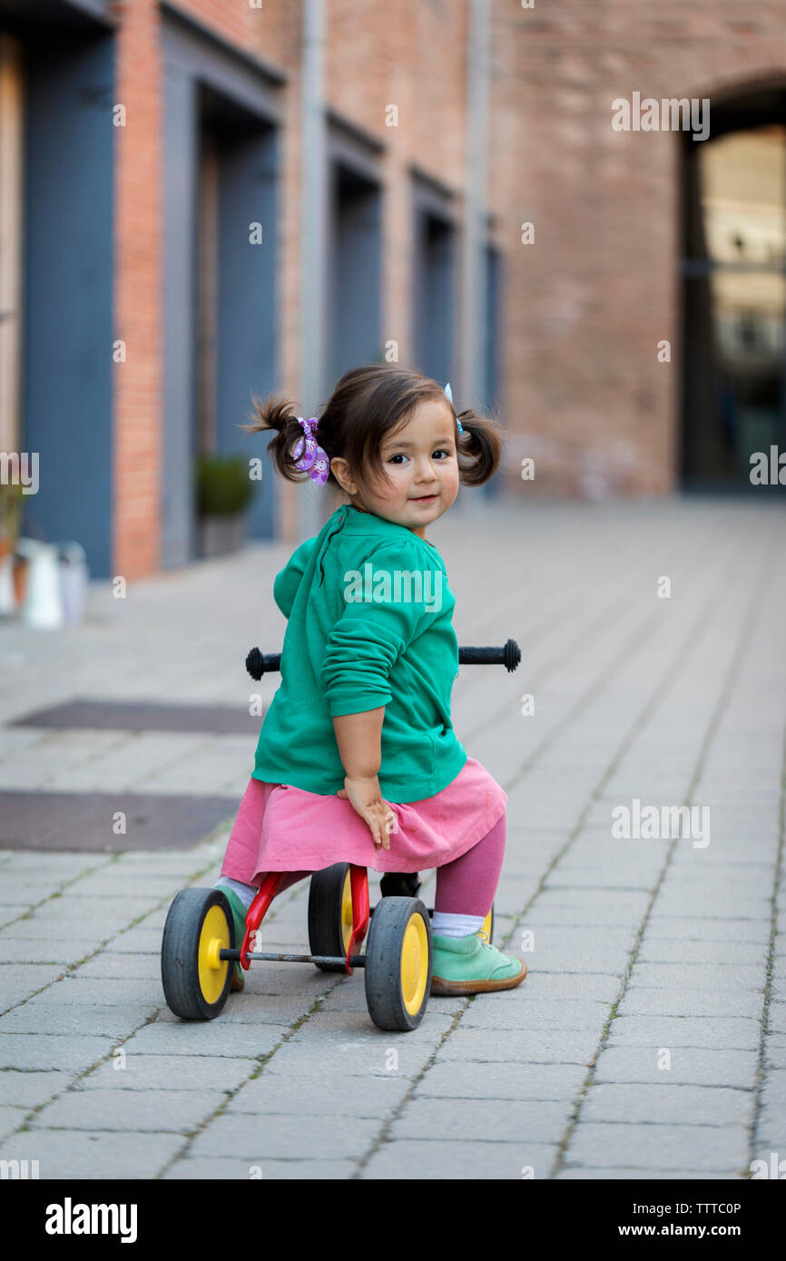 girl riding tricycle