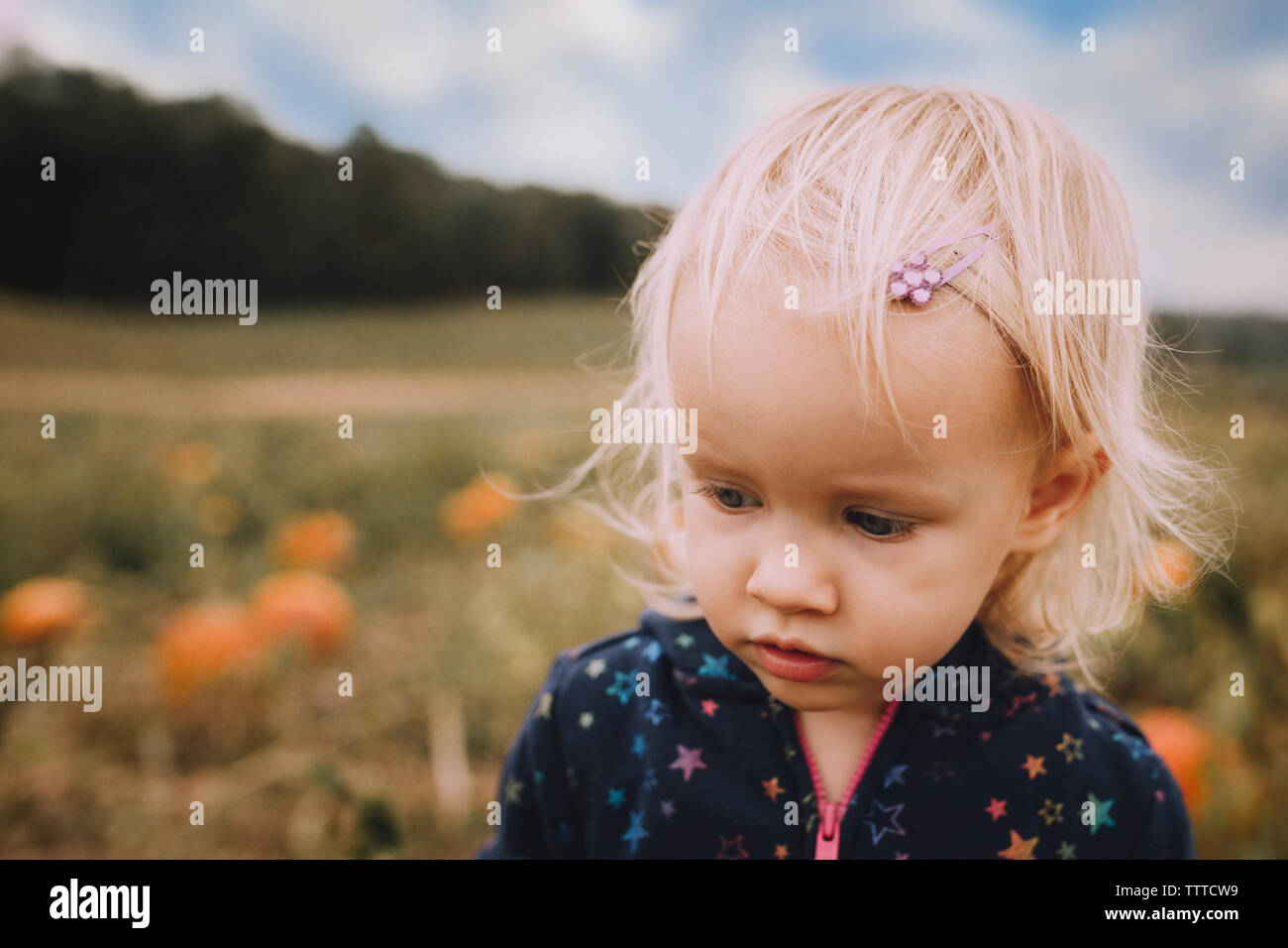 Cute baby girl at pumpkin patch Stock Photo