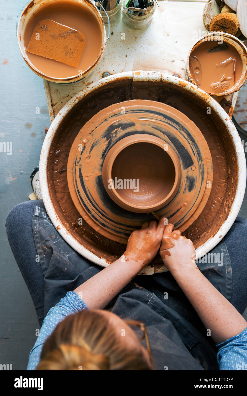 Overhead view of woman working on pottery wheel Stock Photo