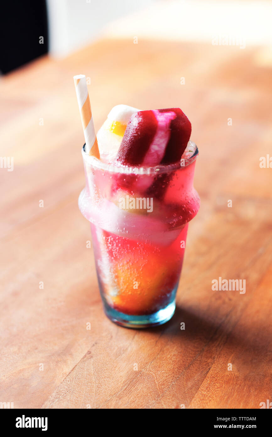 Close-up of flavored ice cubes in glass on table Stock Photo