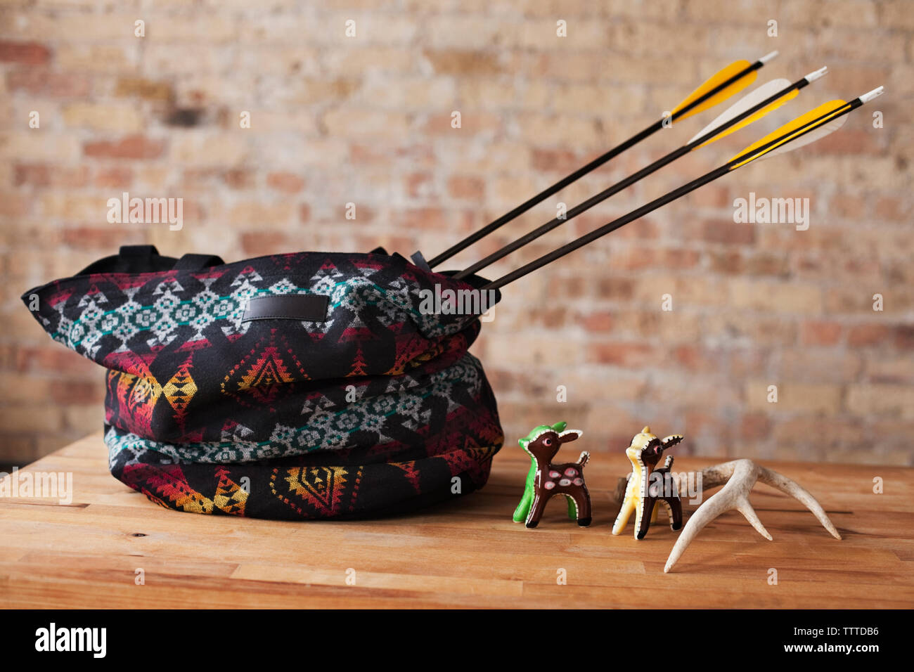 Arrows in bag with animal figurines on table Stock Photo