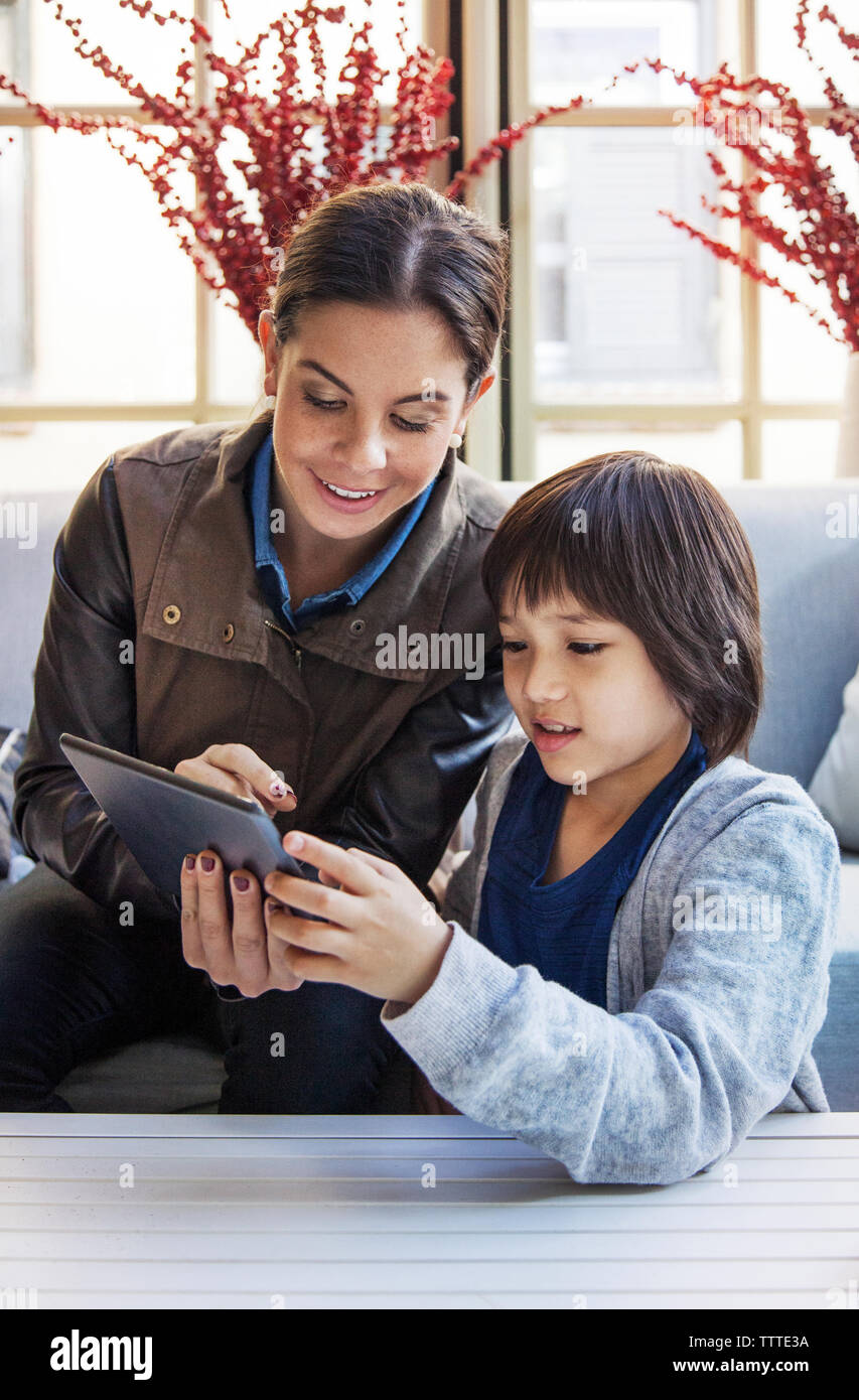 Teacher with student using tablet computer in room during field trip Stock Photo