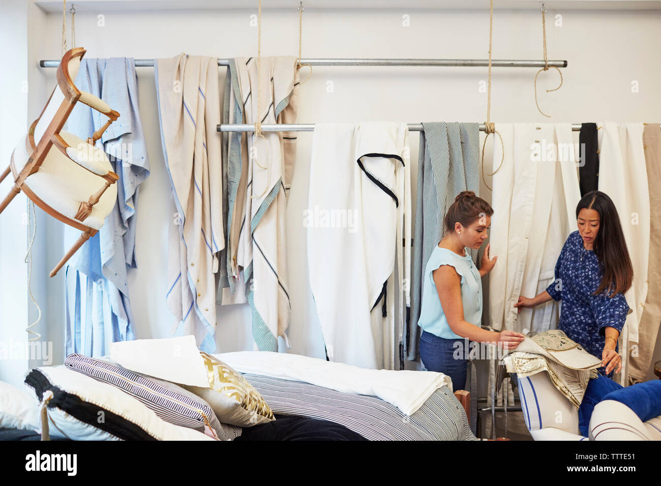 Interior designers selecting curtain samples in workshop Stock Photo