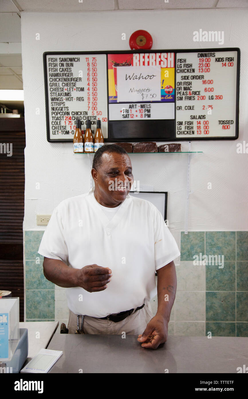 BERMUDA. St. George. Art Mel in his restaurant called Art Me's Spicy Dicy, known for his fish sandwich. Stock Photo
