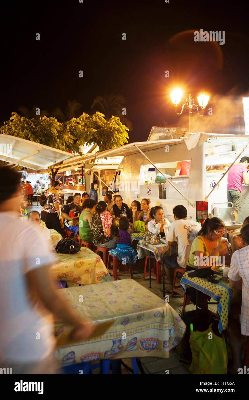 FRENCH POLYNESIA, Tahiti. Roulotte Food Trucks at night at the dock in downtown Papeete. Stock Photo