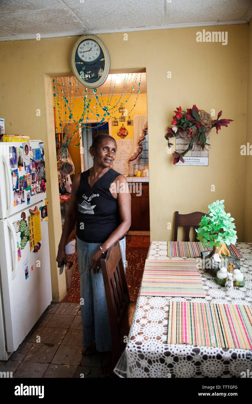 JAMAICA, Port Antonio. A local lady inside her kitchen. Stock Photo