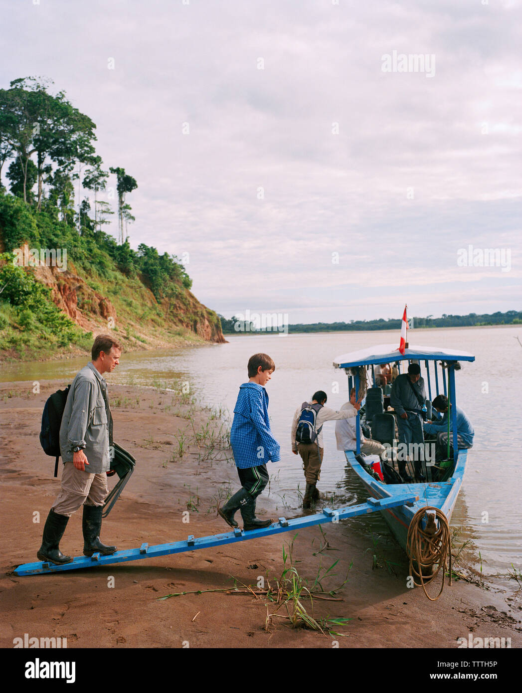 Peru Amazon Rainforest South America Latin America People Getting In Boat At Tambopata River Stock Photo Alamy