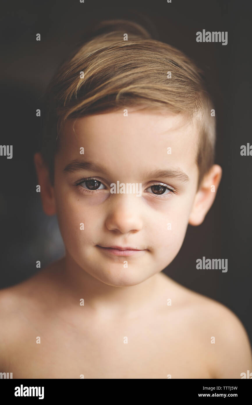 Boy with big brown eyes exudes peacefulness in a child portrait. Stock Photo