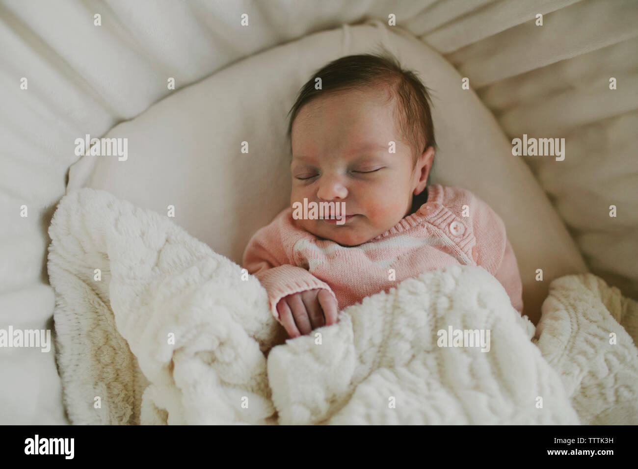 Overhead view of baby girl sleeping in crib Stock Photo