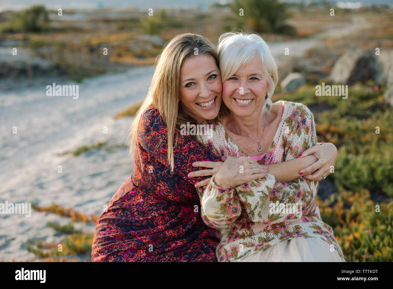 Mother Carrying Daughter on Beach, Majorca, Spain - Stock Photo