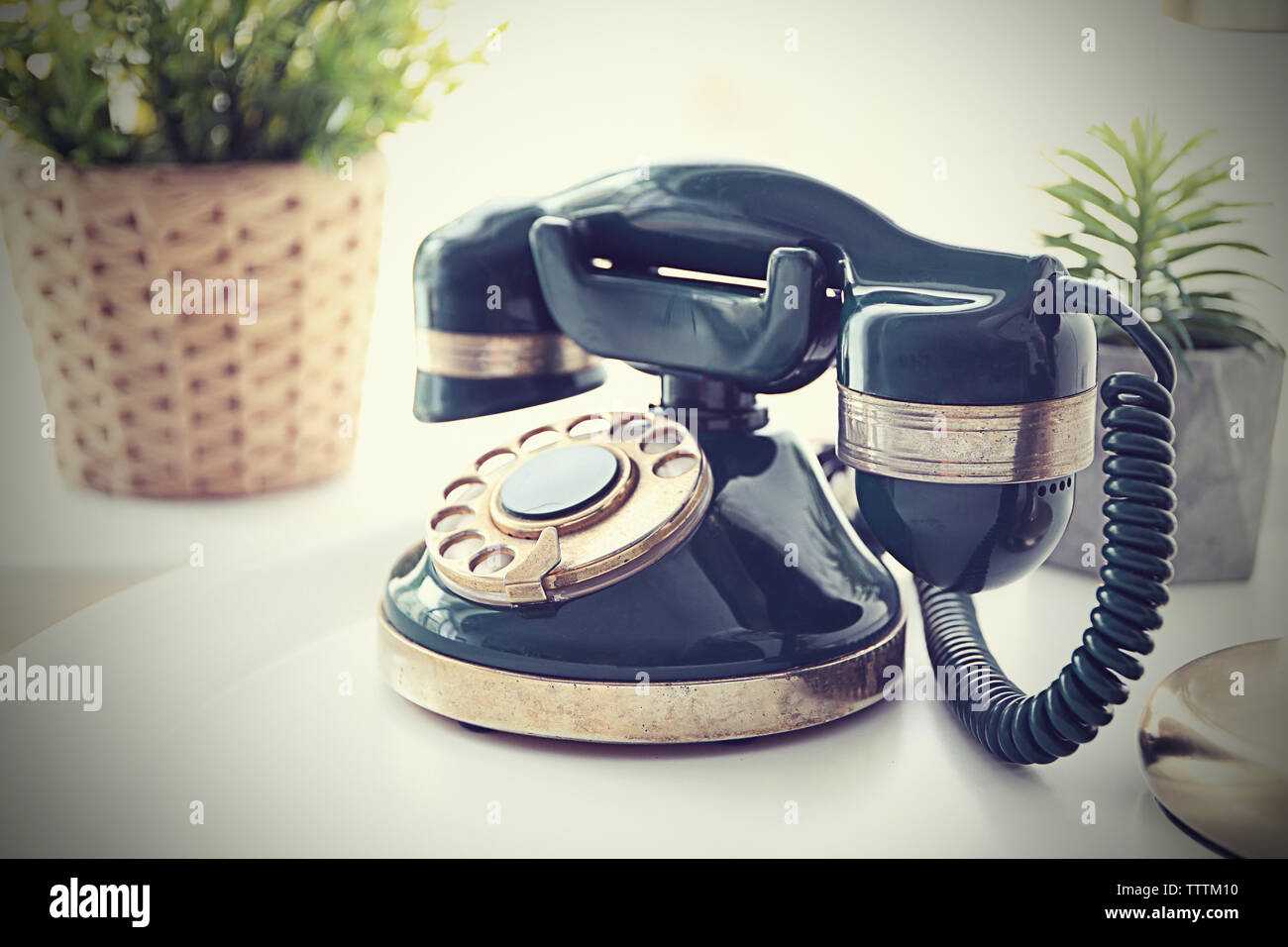Vintage telephone on white table Stock Photo - Alamy
