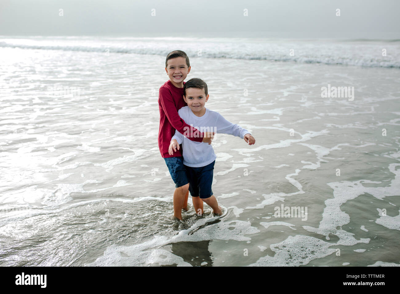 Two boys playing in the sea hi-res stock photography and images - Alamy