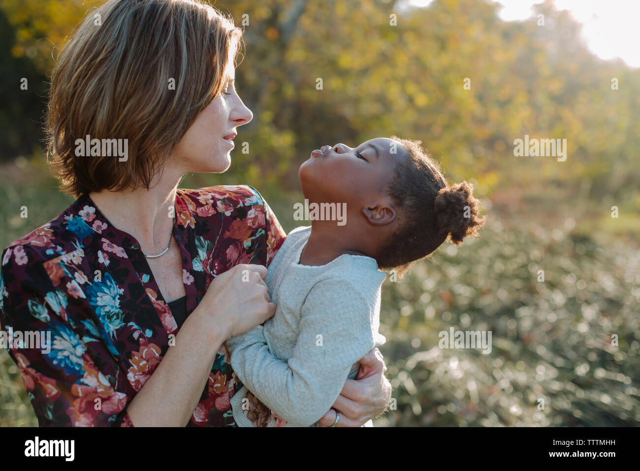 Mother looking at girl puckering Stock Photo