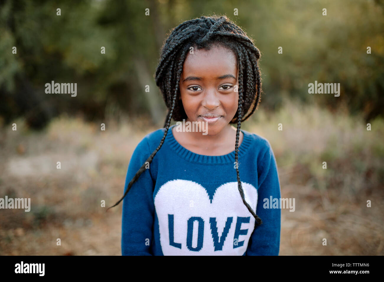 Portrait of girl standing in forest Stock Photo - Alamy