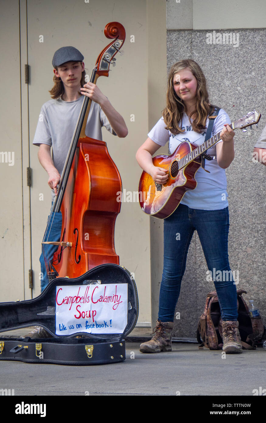 Double bass and acoustic guitar players in  Campbells Calamity Soup musical group busking on the street in  Nashville Tennessee USA. Stock Photo