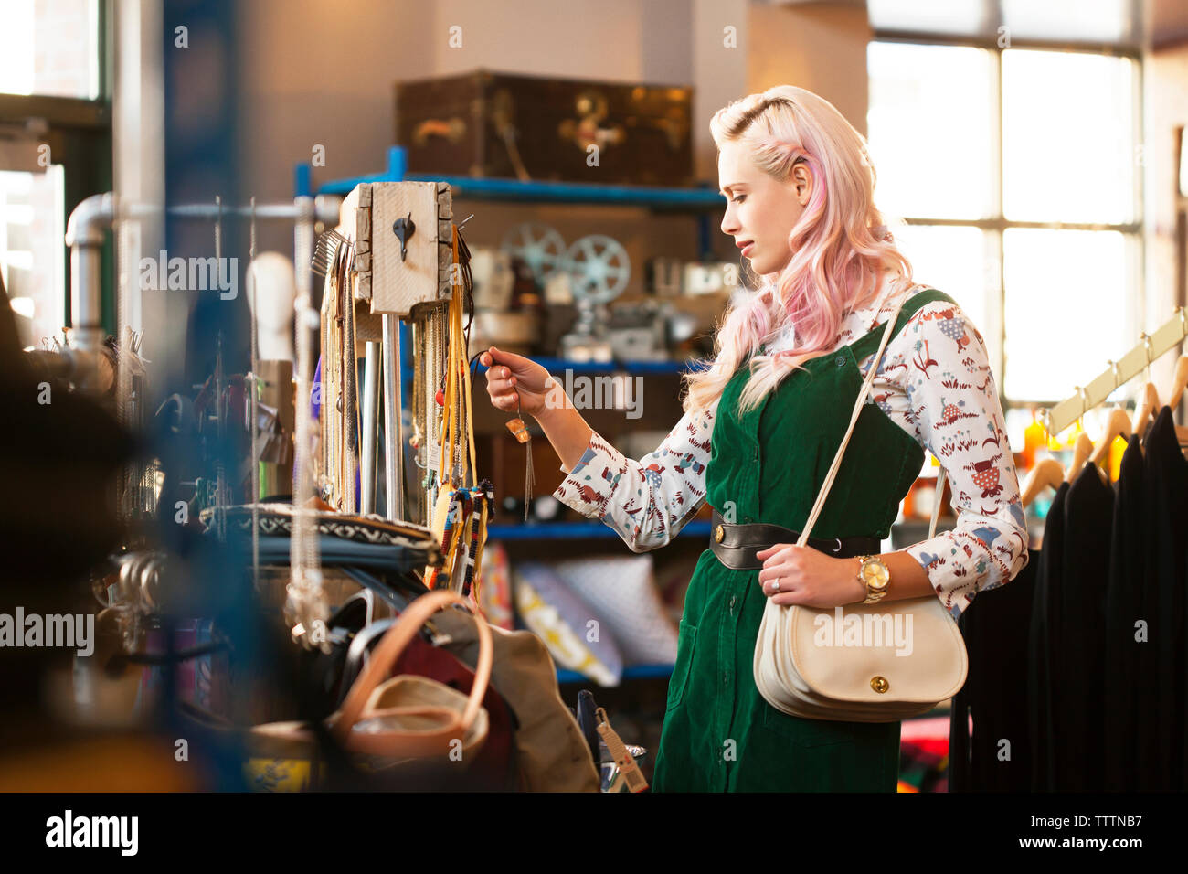 Young female looking at necklace in store Stock Photo