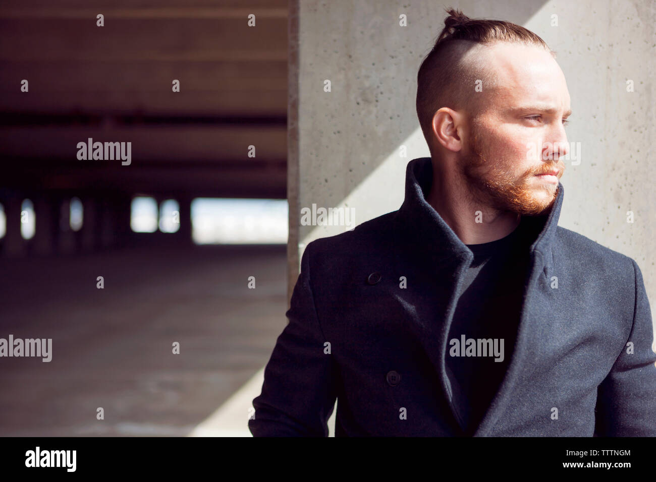 Young man standing front wall hi-res stock photography and images - Alamy
