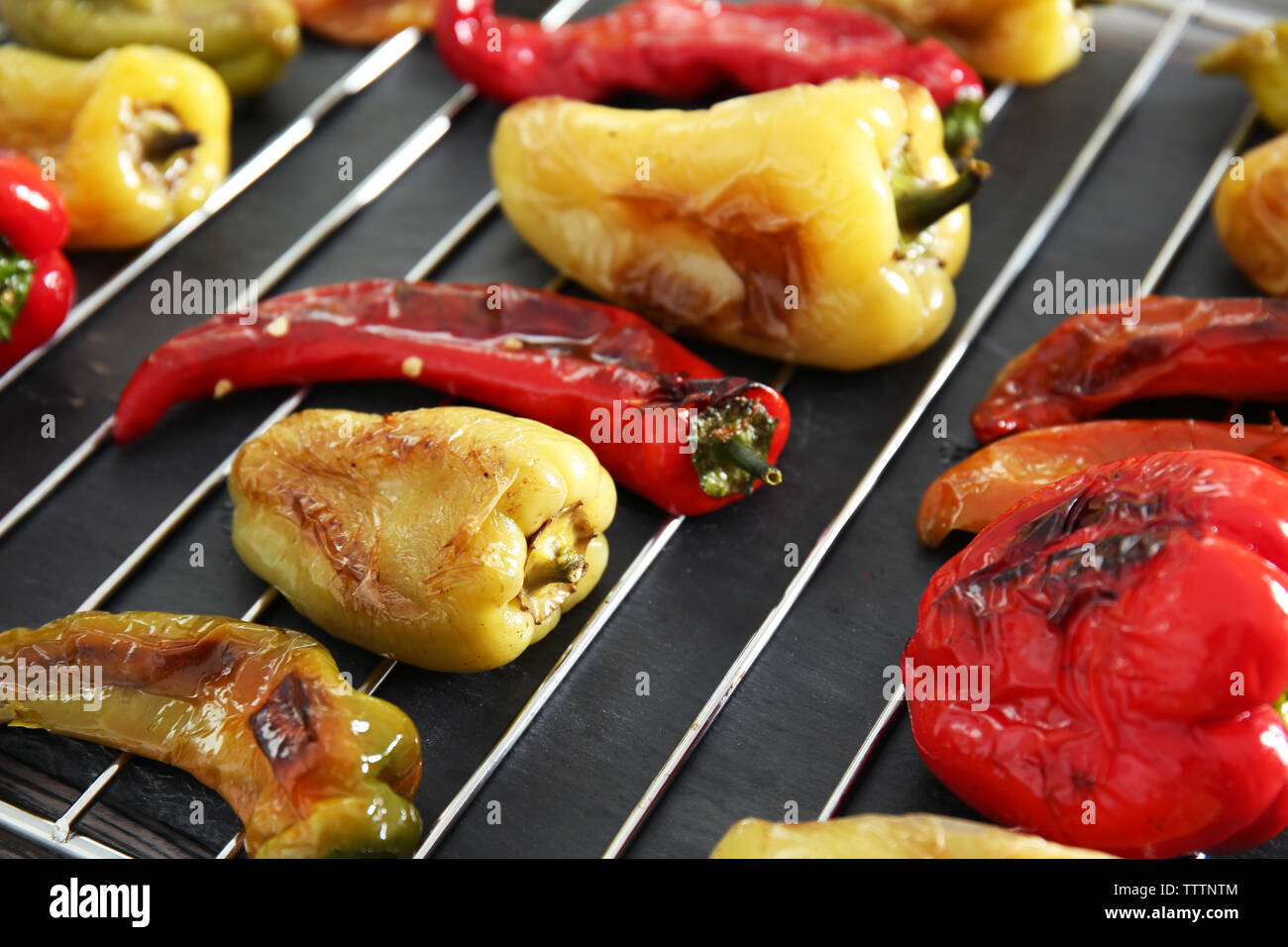 Roasted peppers on grill grid Stock Photo Alamy