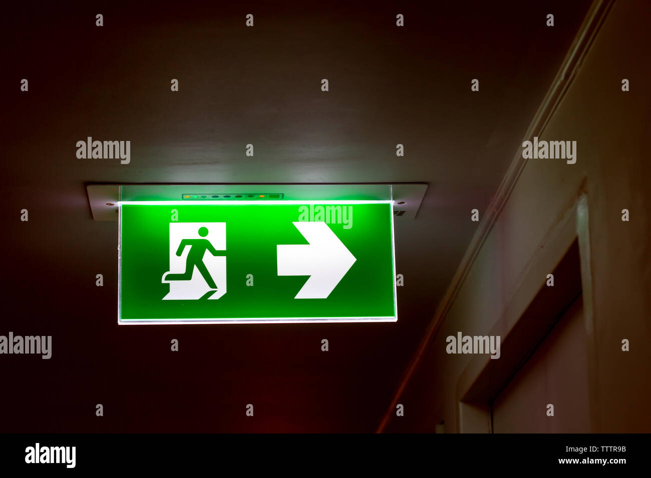 The real safety green sign symbol for go to the fire exit Stock Photo