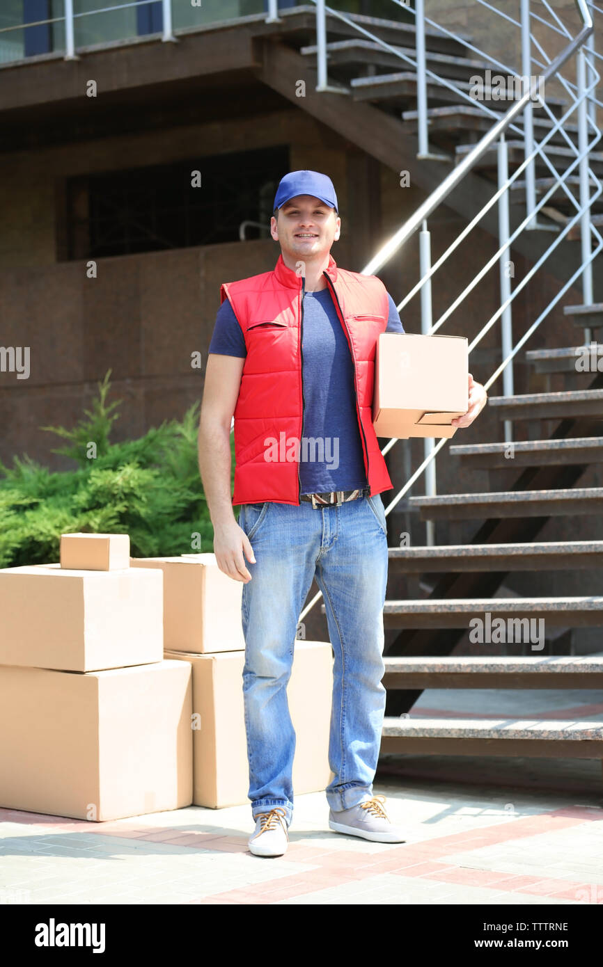 Deliverer carrying box hi-res stock photography and images - Alamy