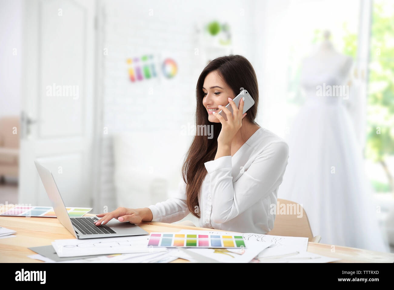 Pretty young dress designer at workplace Stock Photo - Alamy