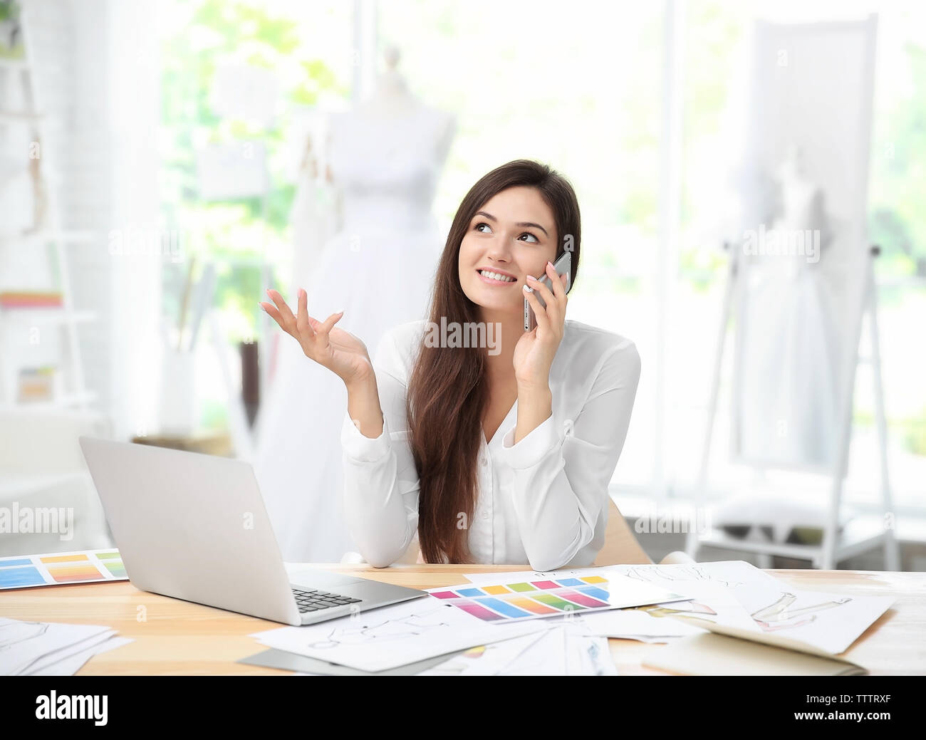 Pretty young dress designer at workplace Stock Photo - Alamy