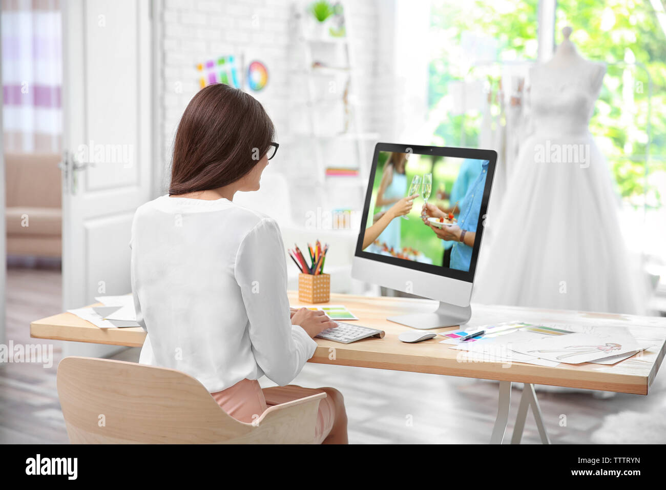 Pretty young dress designer at workplace Stock Photo - Alamy