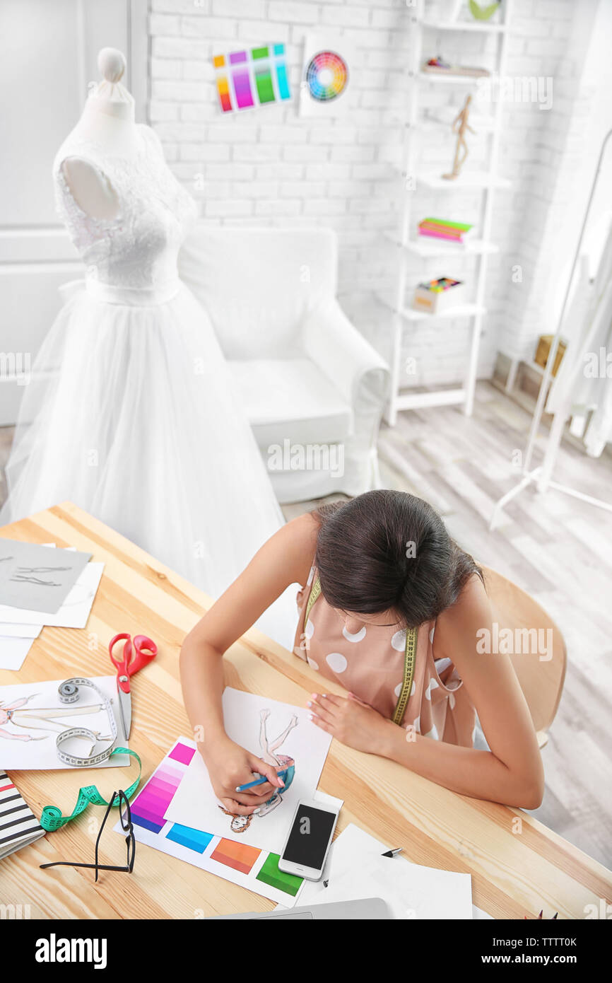 Pretty young dress designer at workplace Stock Photo - Alamy