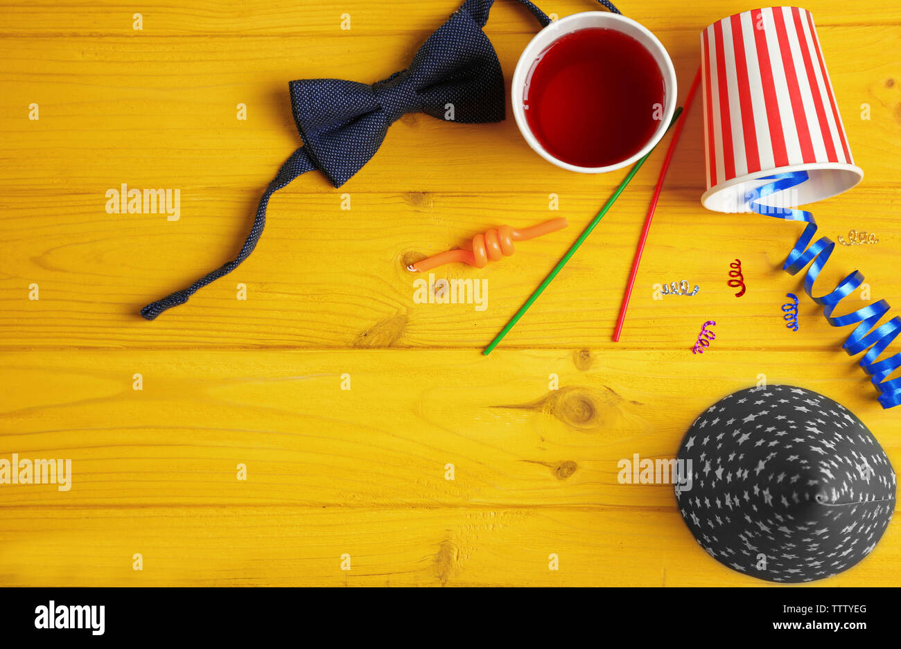 Party accessories on yellow wooden background Stock Photo