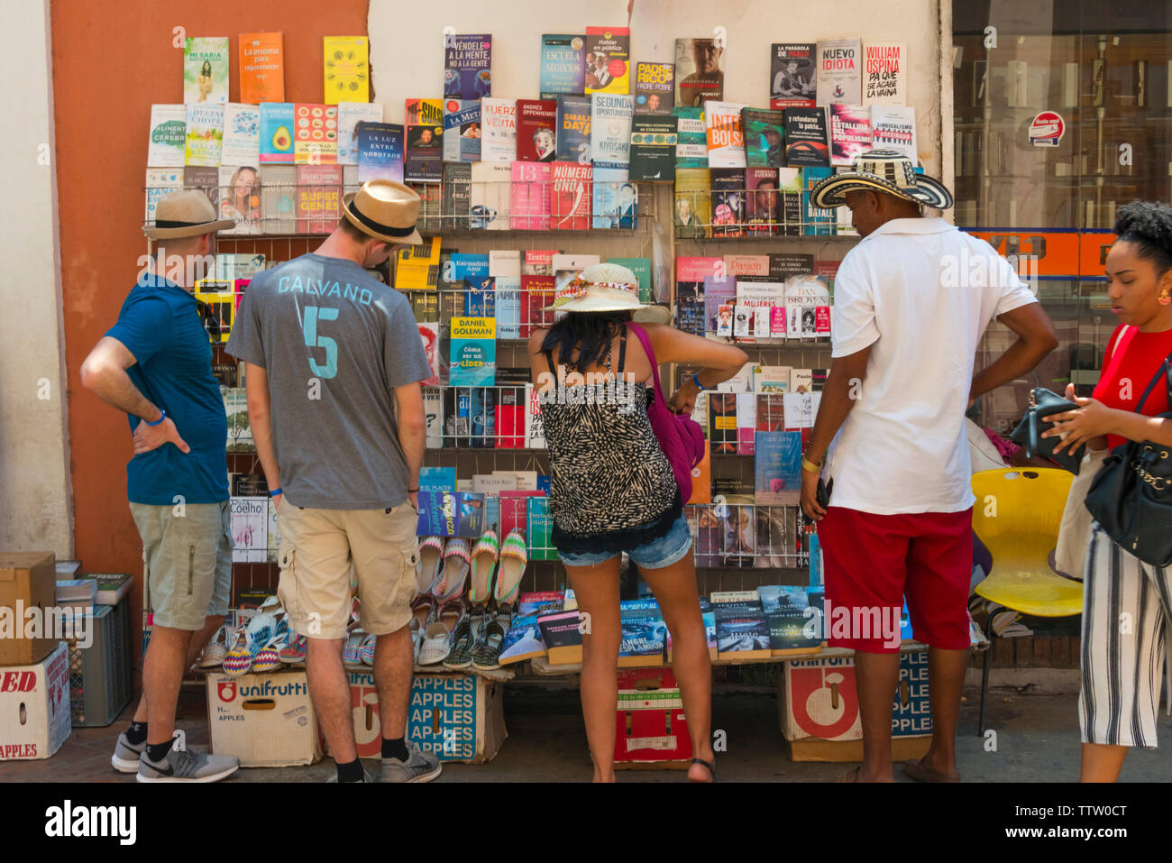 People looking at a booth selling books on the street, Cartagena, UNESCO World Heritage site, Bolivar Department, Colombia Stock Photo