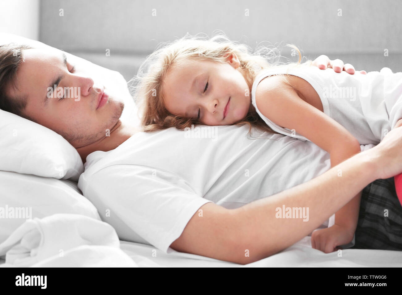 Father And Daughter Sleeping Bed High Resolution Stock Photography and