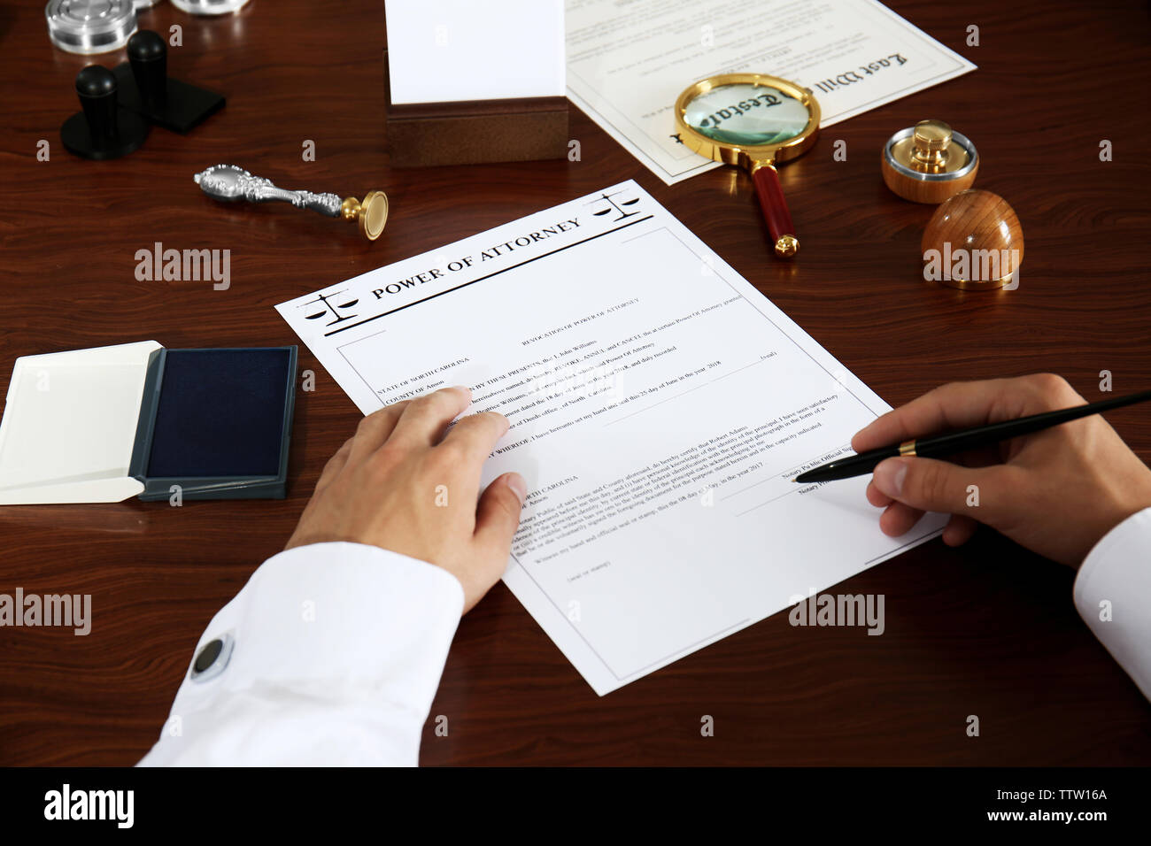 Notary public signing power of attorney in office Stock Photo Alamy