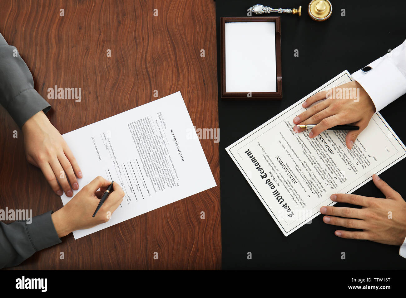 Woman and notary public signing documents Stock Photo Alamy