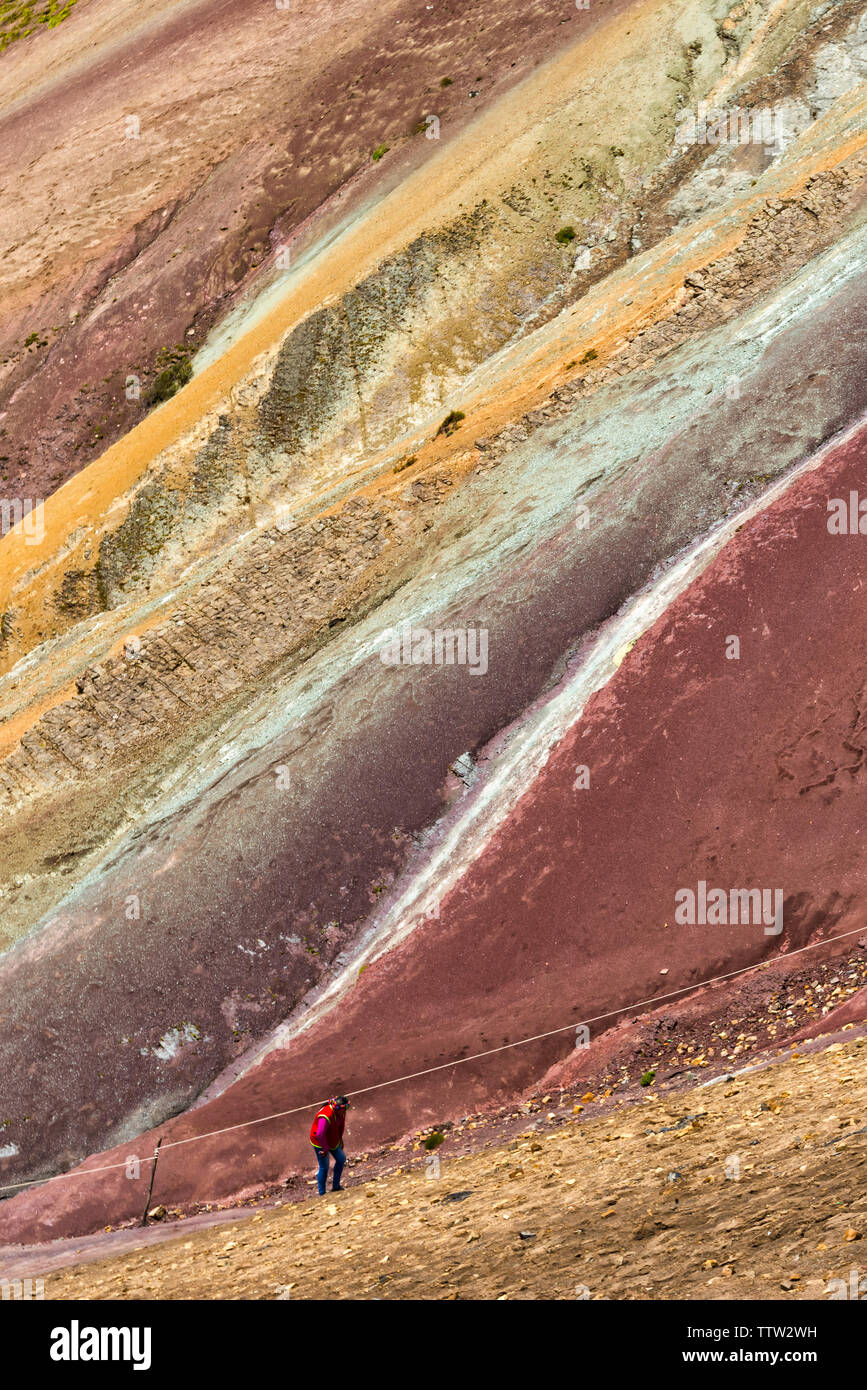 Tourists hiking on the painted hills of the Rainbow Mountain (Vinicunca), Cusco Province, Peru Stock Photo