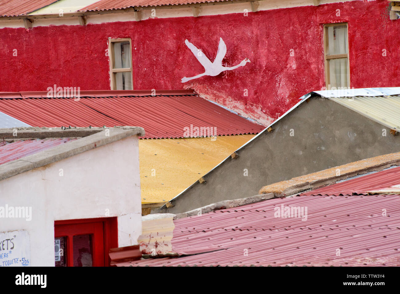 Village house, wall painted with a flying flamingo, Laguna Hedionda, Potosi Department, Bolivia Stock Photo