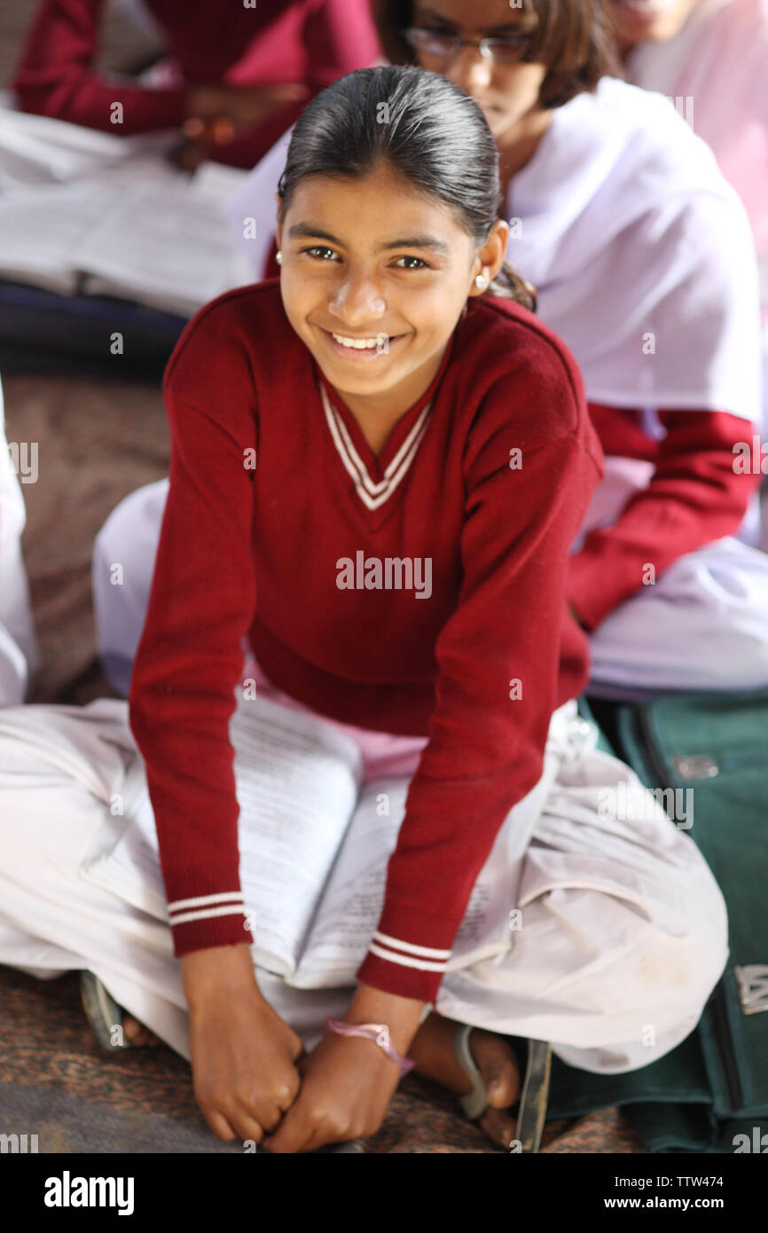 Schoolgirl sitting in a classroom Stock Photo - Alamy
