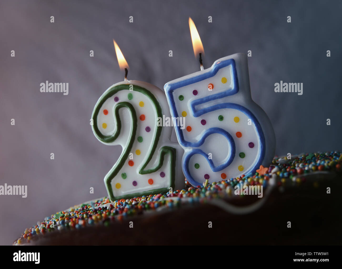 Birthday cake with burning candles on grey background Stock Photo - Alamy