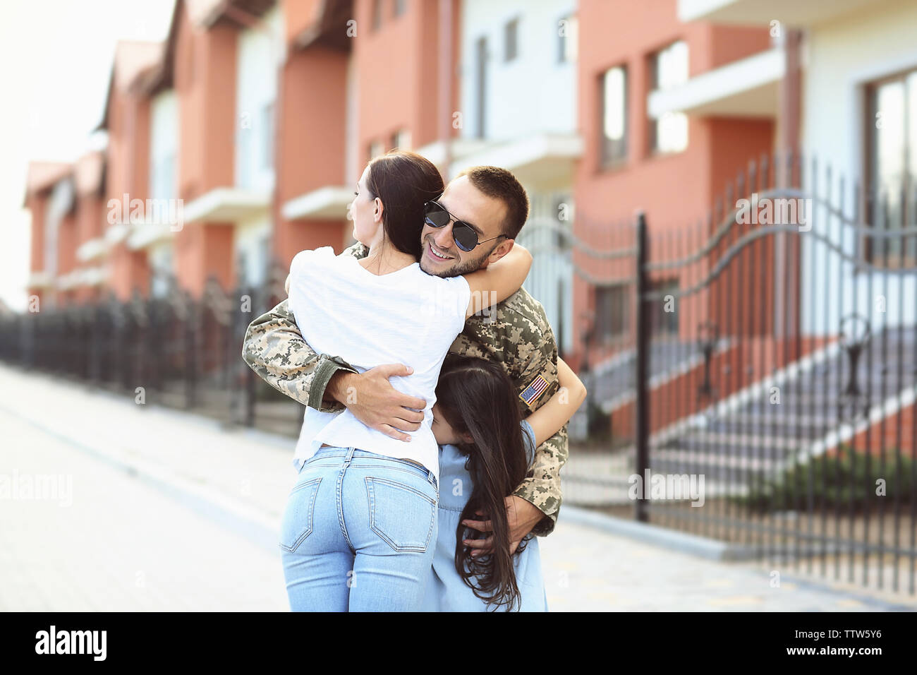 Happy reunion of US army soldier with family Stock Photo