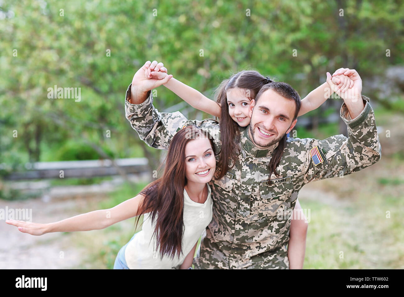 US army soldier with family in park Stock Photo