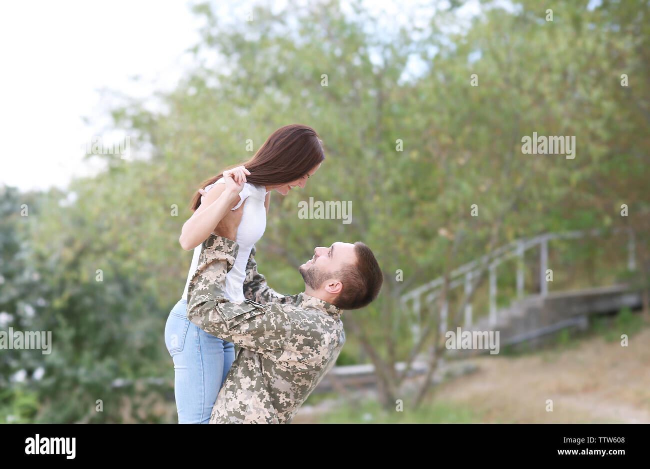 Happy US army soldier with wife in park Stock Photo