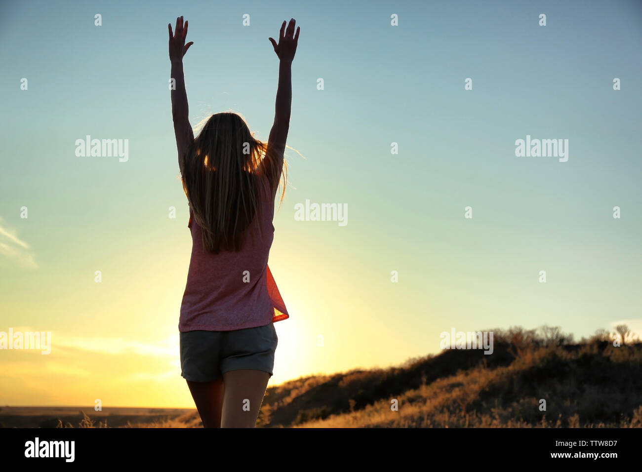 Silhouette of woman on sunset sky background Stock Photo - Alamy