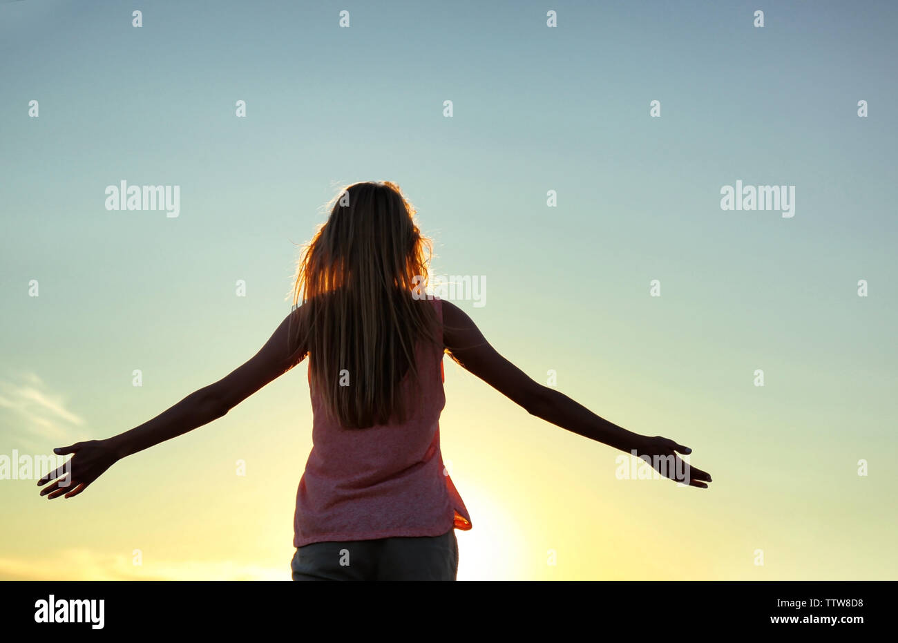 Silhouette of woman on sunset sky background Stock Photo - Alamy